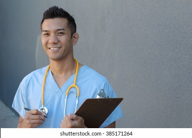 Portrait of young male nurse in scrubs smiling with copy space on the right side of the picture