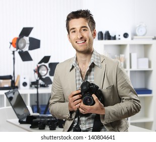 Portrait Of Young Male Photographer With Professional Digital Camera