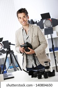 Portrait Of Young Male Photographer With Professional Digital Camera