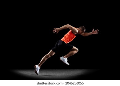 Portrait Of Young Male Professional Athlete In Uniform Training Running Isolated Over Black Studio Background. Maintaining Health And Strength. Concept Of Sport, Healthy Lifestyle, Motion, Ad