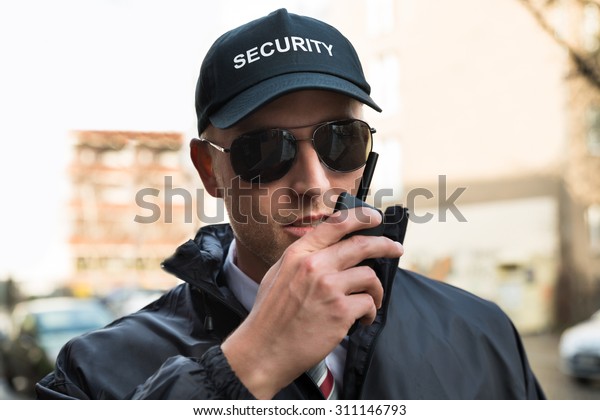 Portrait Young Male Security Guard Talking Stock Photo 311146793 ...