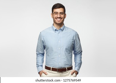 Portrait Of Young Male Teacher In Blue Shirt Isolated On Gray Background