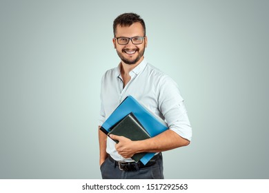 Portrait Of A Young Male Teacher On A Light Background. Teacher's Day Knowledge Day Back To School Study Online Learning