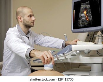 Portrait of young male technician operating ultrasound machine in white dress