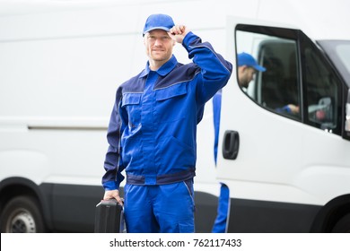 Portrait Of A Young Male Worker In Blue Uniform