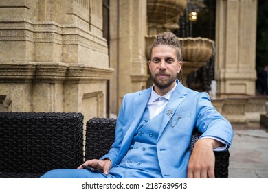 Portrait Of A Young Man 25 Years Old With A Hipster Look In A Blue Three-piece Business Suit.