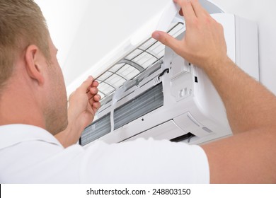 Portrait Of A Young Man Adjusting Air Conditioning System - Shutterstock ID 248803150