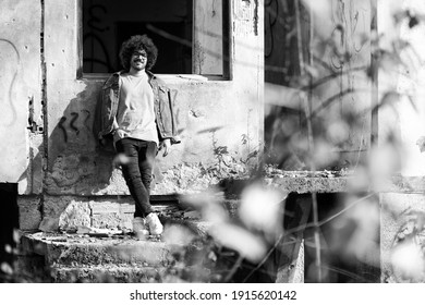 Portrait Of A Young Man Afro Hair Posing At Abandoned House Outside