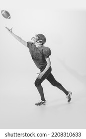 Portrait Of Young Man, American Football Player Posing, Throwing Ball. Black And White Photography. Concept Of Sport, Retro Style, 20s, Fashion, Action, College Sport, Youth Culture