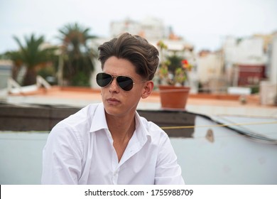 Portrait Of Young Man With Aviator Glasses On Rooftop.