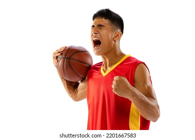 Portrait Of Young Man, Basketball Player With Ball In Red Uniform Screaming, Growing Team Spirit Isolated On White Studio Background. Concept Of Healthy Lifestyle, Professional Sport, Hobby, Strength