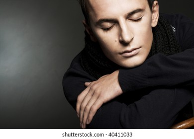 Portrait Of Young Man In Black Scarf With Closed Eyes