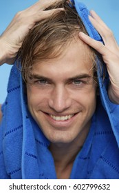 Portrait Of Young Man With Blue Towel On Head