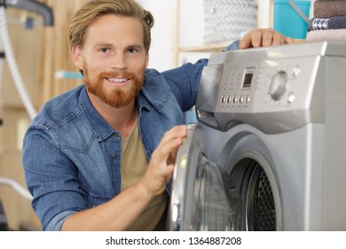 Portrait Of Young Man By Washing Machine