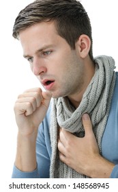 Portrait of young man coughing with fist
