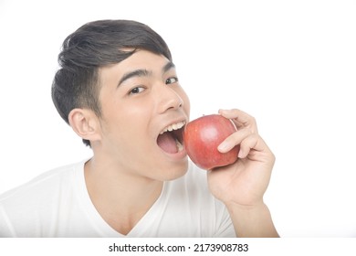 Portrait Of Young Man Eating Apple

