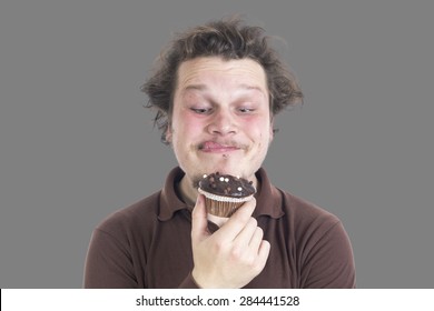 Portrait Of A Young Man Eating A Muffin