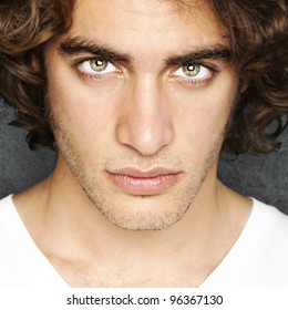 Portrait Of Young Man Face Against A Vintage Wall