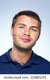 Portrait Of Young Man With Face Full Of Lipstick Marks Of Kisses