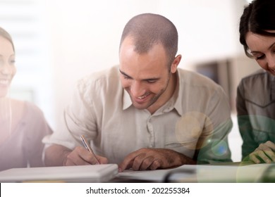 Portrait Of Young Man Filling In Application Form