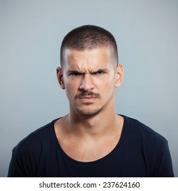 Portrait Of A Young Man Frowning. Studio Shot.