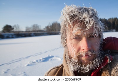 Portrait Of The Young Man With Frozen Icy Hairs On Head And Beard