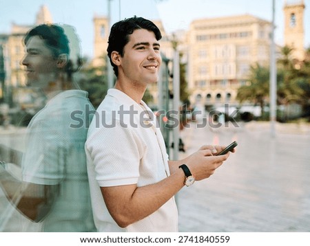 Portrait of a young man guy using a phone in the street