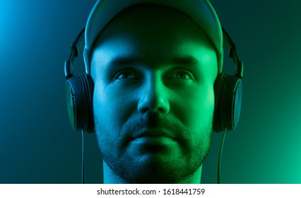 Portrait Of A Young Man With Headphones. Dual Tone Lighting