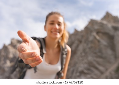 Portrait Of A Young Man Helping You To Reach The Top Of A Mountain