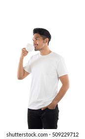 Portrait Of Young Man Holding A Cup Of Coffee Isolated On White Background.