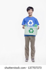 Portrait Of Young Man Holding Recycling Bin, Studio Shot