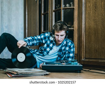 Portrait Of Young Man At Home Listening To The Vinyl Records, Relaxing And Dreaning