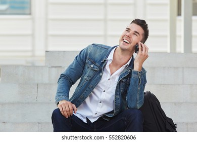 Portrait of young man laughing and talking on mobile phone - Powered by Shutterstock