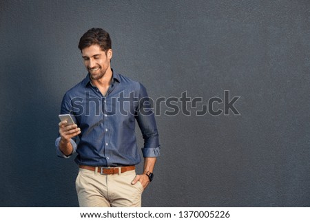 Similar – Image, Stock Photo Hispanic guy leaning on hand sitting against colorful illumination with opened mouth
