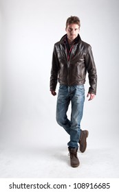 Portrait Of Young Man With Leather Jacket Against White Background.