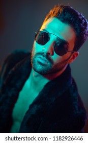 Portrait of young man in leather jacket and sunglasses