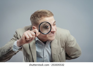 Looking through. Looking through a Magnifying Glass. Man looking with a Magnifying Glass. Man looking through Magnifying Glass. Man looking through.