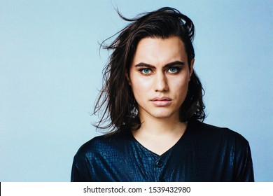 Portrait of a young man with make up and long hair in studio	 - Powered by Shutterstock