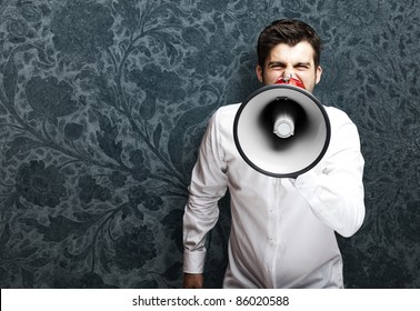 Portrait Of Young Man With Megaphone Against A Vintage Background