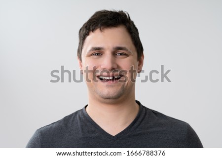 Portrait Of Young Man With Missing Tooth