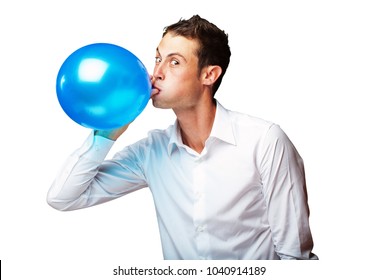 Portrait Of Young Man BlowingÂ Balloon On White Background