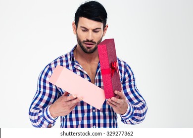 Portrait Of A Young Man Opening Gift Box Isolated On A White Background