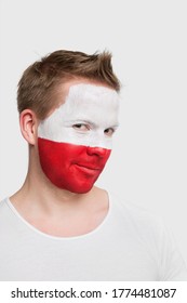 Portrait Of Young Man With Polish Flag Painted On Face Smiling Against White Background