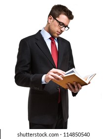 Portrait Of A Young Man Reading A Book. Isolated On White