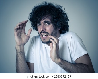 Portrait of young man in shock with scared face making frightened gestures and looking at something scaring. Human emotions feelings and facial expression. Isolated on white background.