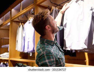 Portrait Of A Young Man Shopping For Clothes In Store