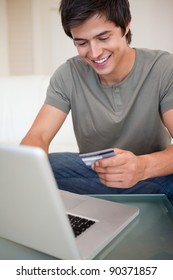 Portrait Of A Young Man Shopping Online In His Living Room