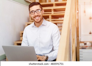 Portrait of young man sitting at the stairs in office - Shutterstock ID 483591751