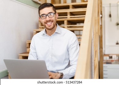 Portrait of young man sitting at the stairs in office - Shutterstock ID 513437284