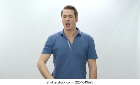 Portrait of young man sneezing from allergies. Health problem and allergy concept. Sick man with cold and allergy symptoms sneezing on white background in studio The sick man feels bad. - Powered by Shutterstock